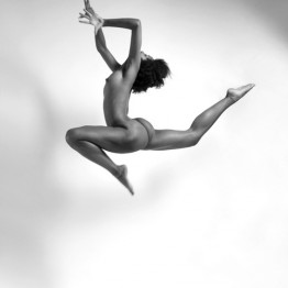 naked brunette jumping in the air