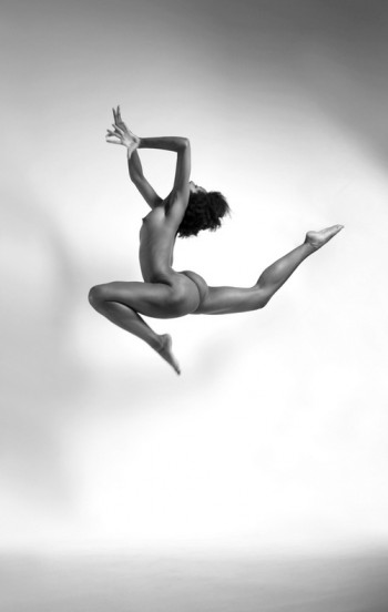 naked brunette jumping in the air