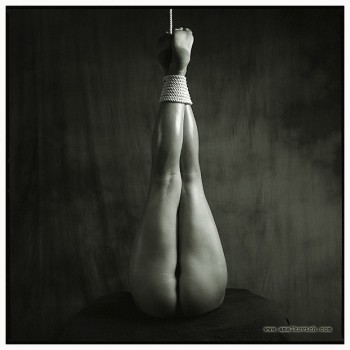 fetish bondage photo of a woman with her legs tied